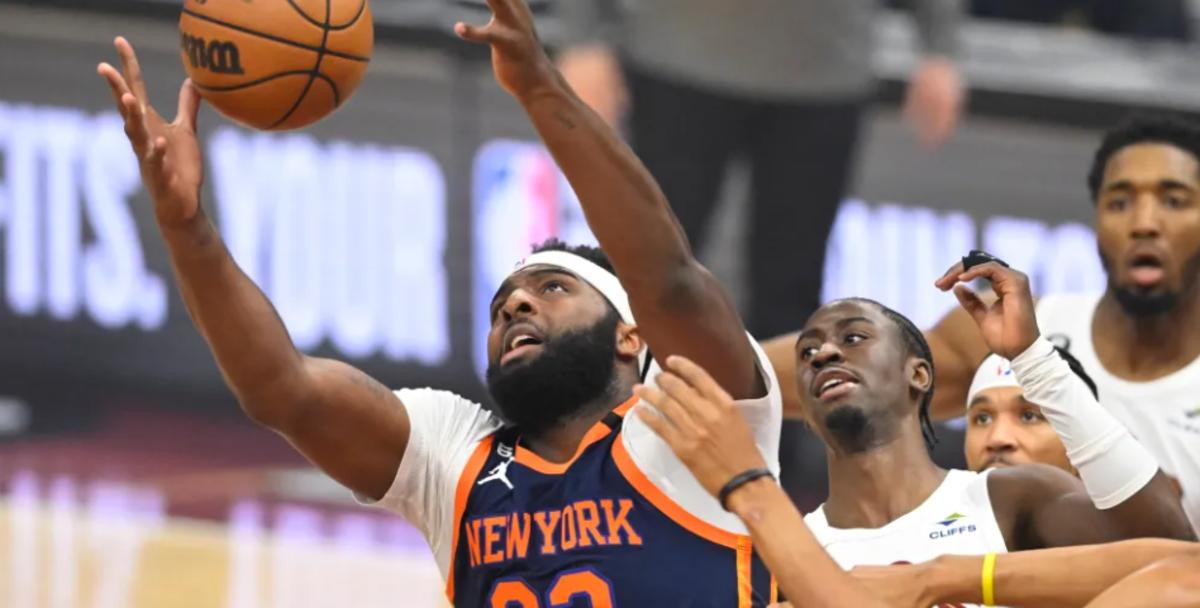 Mitchell Robinson (in blue) hauls in an offensive rebound during the Knicks' playoff series against the Cleveland Cavaliers